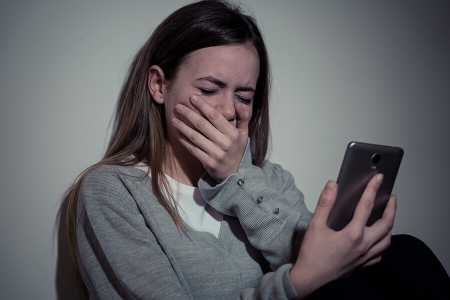 upset girl looking at mobile phone upset girl looking at mobile phone