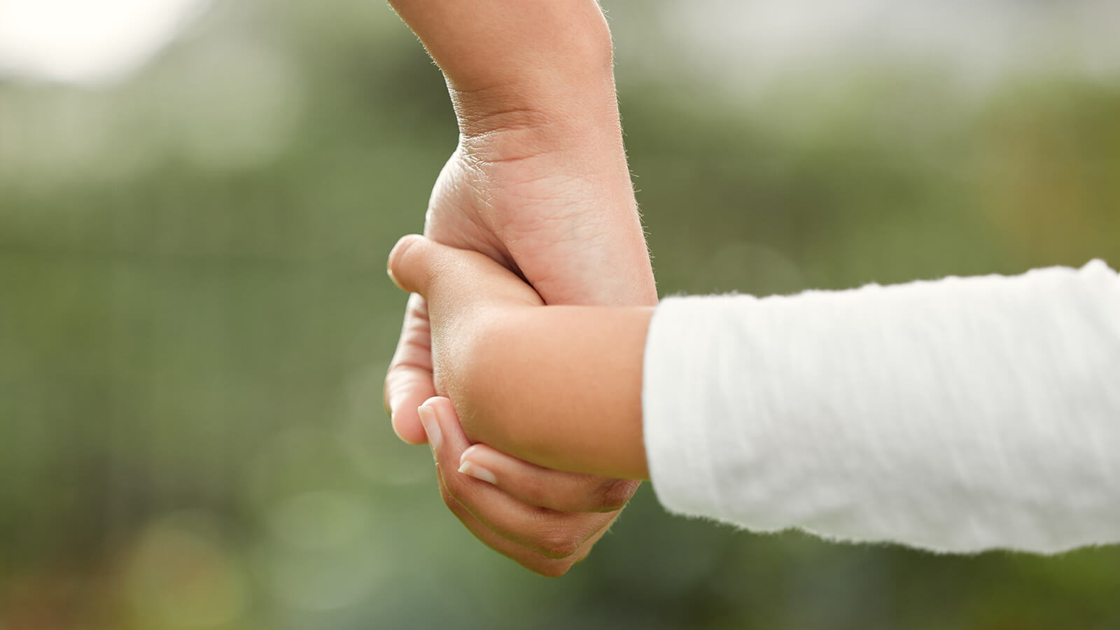 adult and child holding hands