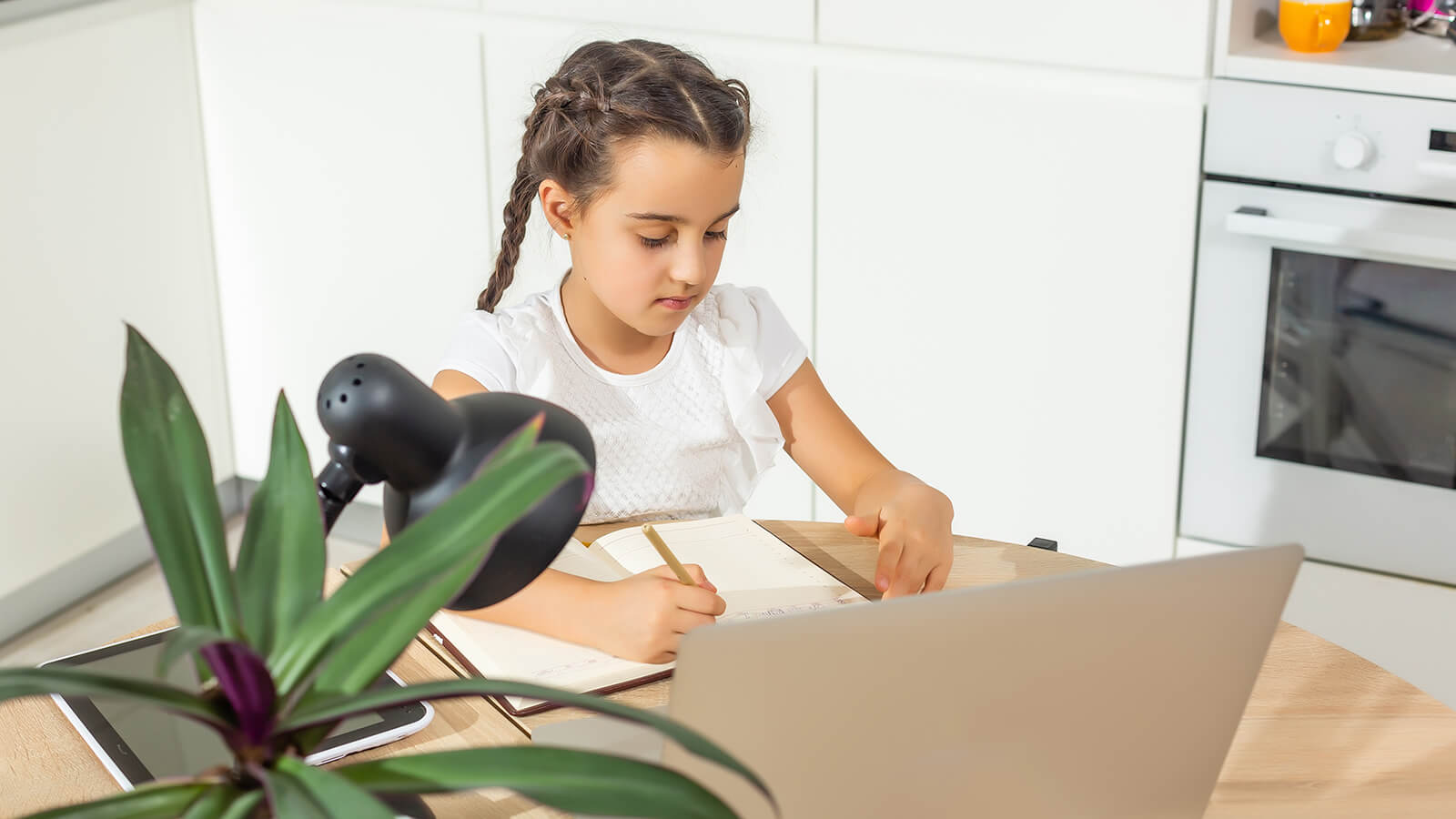 young girl studying in a kitchen